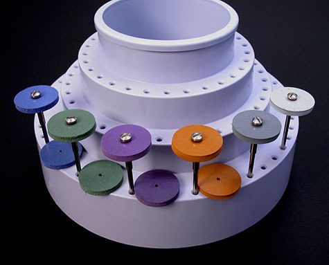 Close-up view of a tool organizer holding a variety of abrasive wheels