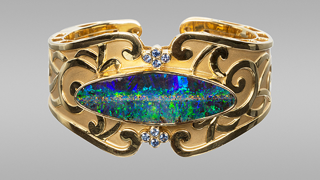 Boulder opal and sapphires in cuff bracelet.