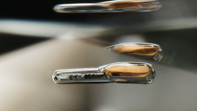 Figure 1. Mineral inclusions in diamond. This connected pair of green clinopyroxene and orange garnet indicates that diamond growth occurred within an eclogitic mantle host rock. Photomicrograph by Nathan Renfro; field of view 2 mm.