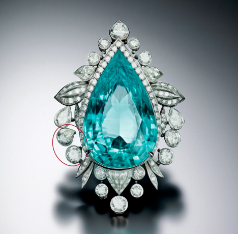 Figure 5. Another image output from Midjourney 5.2, using the prompt “watercolor style, pear-shaped Paraiba tourmaline brooch set in platinum with a halo of diamonds surrounding it.” Circled in red are irregularly shaped gems and “floating” bezels.