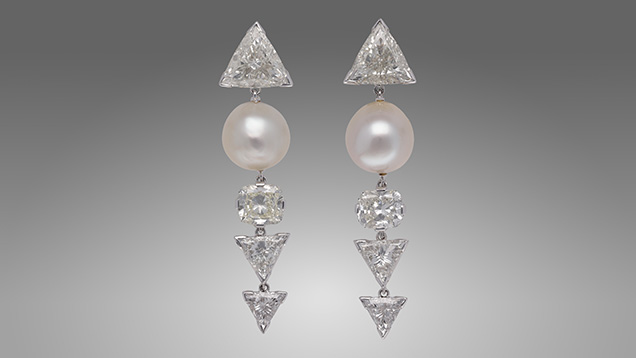 Figure 1. Two partially drilled button-shaped light cream assembled pearls weighing 7.40 and 9.37 ct, respectively, mounted in a pair of earrings. Photo by Gaurav Bera.