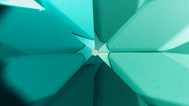 Figure 5. This “umbrella effect” at the culet of a diamond was created by cyclotron treatment, a type of artificial irradiation. Photomicrograph by Nicole Ahline; field of view 2.90 mm.