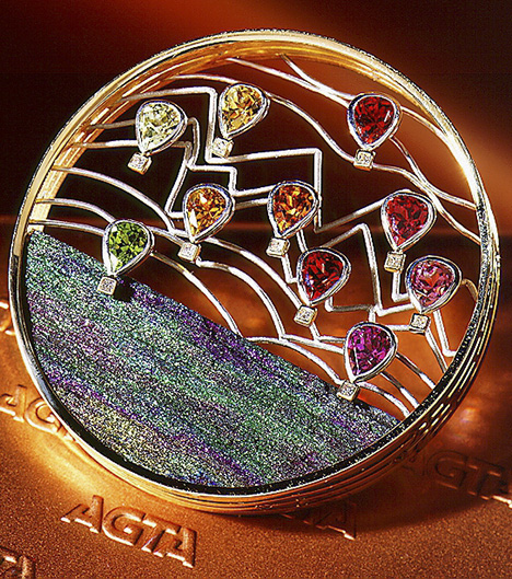 Flying Free brooch with garnets and Brazilian rainbow hematite.