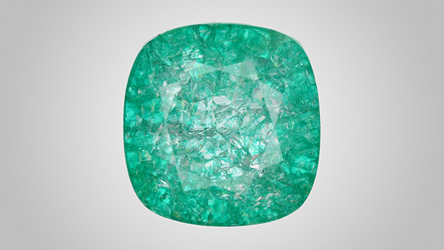 Figure 1. Face-up appearance of a quench-crackled and dyed laboratory-grown colorless sapphire, measuring 13.10 × 12.73 × 7.51 mm. Photo by Adriana Gudino.