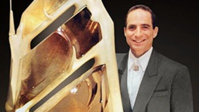 Glenn Lehrer next to the rutilated quartz carving “Bahia,” created with Lawrence Stoller.