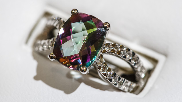 Mystic Topaz. Surface treatment with metallic oxides resulted in the unique look of this ring’s gem, marketed as mystic topaz. - Courtesy Livingstone Jewelry