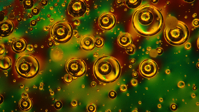 Koivula_75505_636x358.jpg. Droplets of dew or rainwater with air bubbles floating in them captured in amber from the Dominican Republic. Magnified 5X. Photo by John Koivula/GIA.