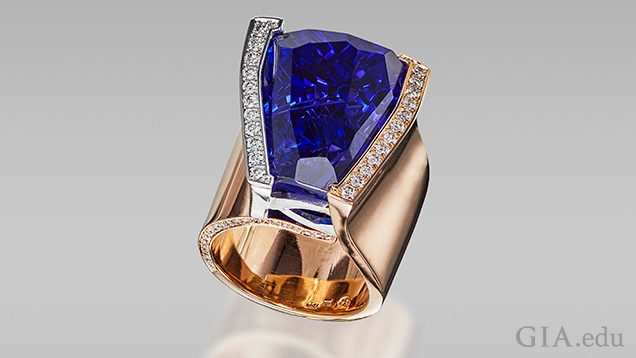 Blue freeform tanzanite in ring.. Figure 1. This ring is set with a spectacular 27.20 ct vivid blue freeform tanzanite. Photo courtesy of Sonja Kreis Unique Jewelry.